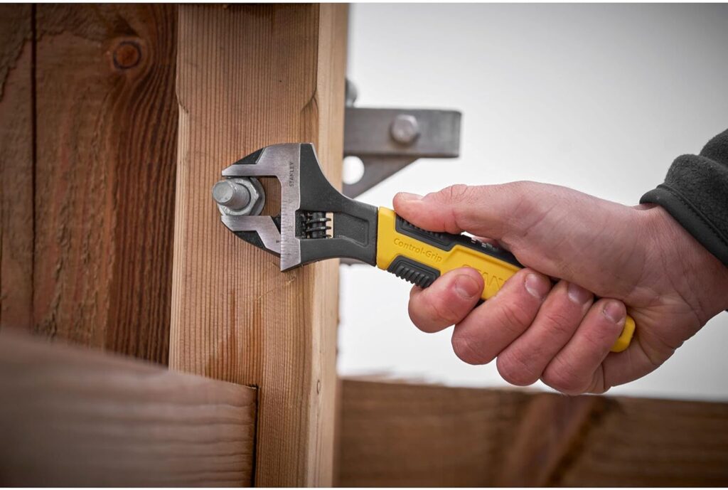 Carpenter using a Stanley adjustable wrench spanner for carpentry