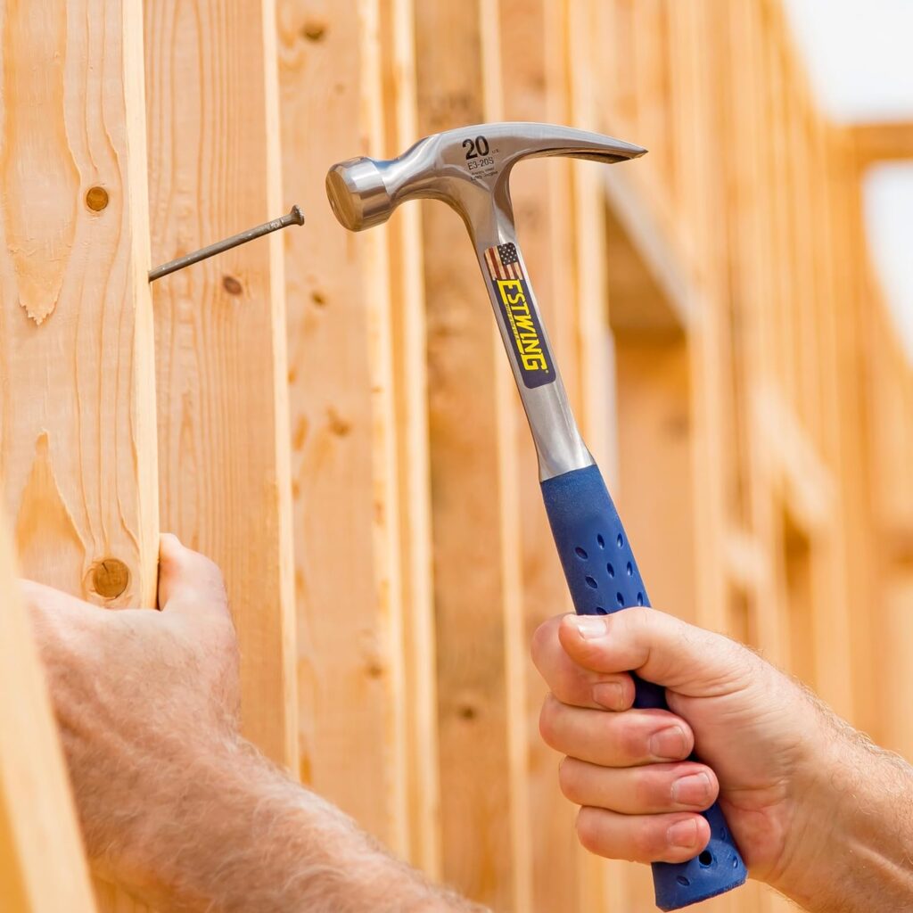 A carpenter hammering a nail with an Estwing 20oz claw hammer for carpentry